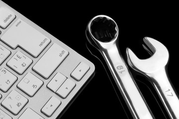 Chrome Plated Wrenches And Wireless Keyboard Isolated On Black