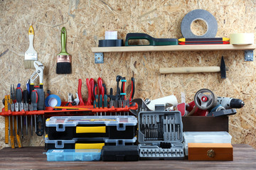 Set of tools in workshop on plywood background