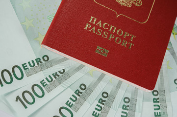 passport in the background of one hundred Euro banknotes in - time to travel
