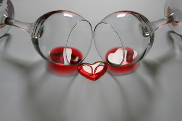 Two glasses and heart shaped splash of red wine