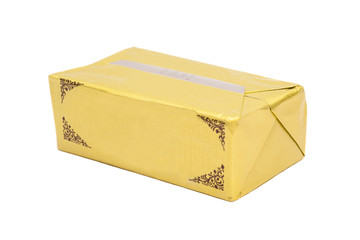 Stick of wrapped butter on white background
