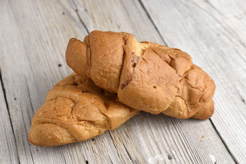 Croissant on old wooden table