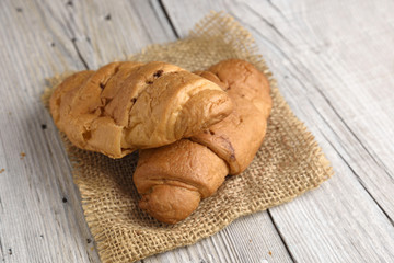 Croissant on old wooden table