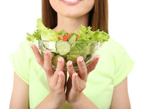 Young woman with glass bowl of diet salad isolated on white