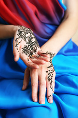 Image of henna on female hands, closeup