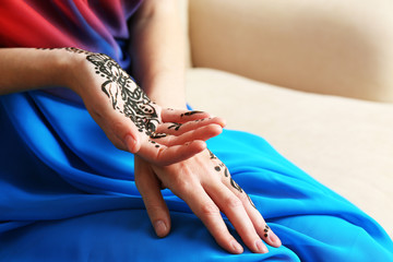 Image of henna on female hands, closeup