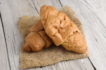 Croissant on old wooden table
