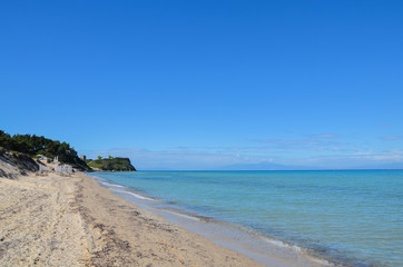 Fototapeta na wymiar Long white sand beach along the translucent turquoise Mediterran