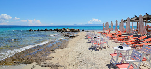 Beautiful white sand beach with sun beds, tables, chairs and par