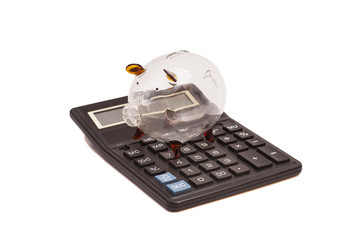 Piggy bank and callculator isolated on white background