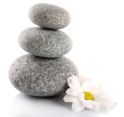 Obraz na płótnie Canvas Stack of spa stones with chamomile isolated on white