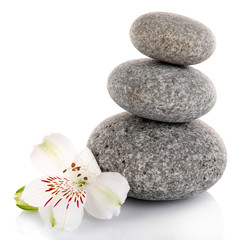 Stack of spa stones with alstroemeria isolated on white