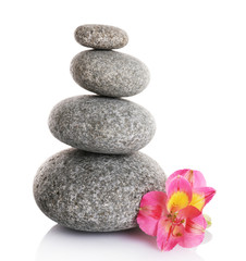 Obraz na płótnie Canvas Stack of spa stones with pink flower isolated on white
