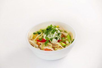 Bowl of fresh summer sliced vegetables salad with cream isolated