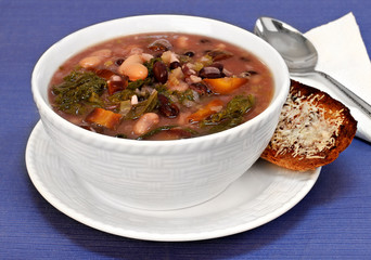 Kale, bean and vegetable soup close up.