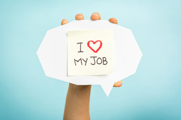 Yellow adhesive note on speech bubble with "I love my job" words.