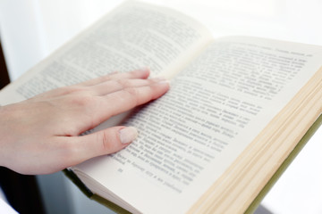 Fototapeta premium Woman reading book near window