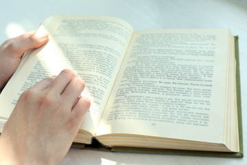Naklejka premium Woman reading book near window