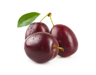 Plums with leaves.