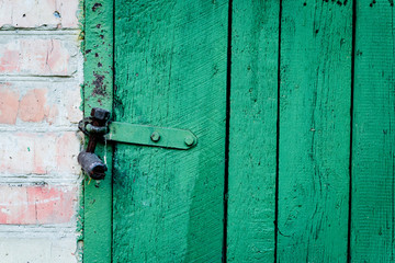 Wooden texture of green color with scratches and cracks, which can be used as a background