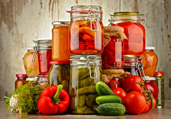 Jars with pickled vegetables and fruity compotes