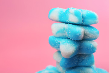 Stack of blue candies on pink background