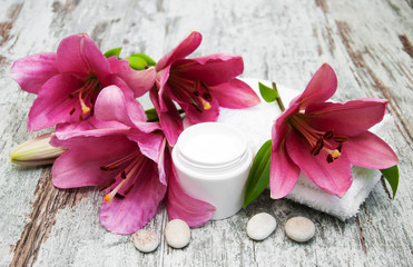 Fototapeta na wymiar cosmetic cream and pink lily flower