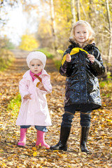 little girls wearing rubber boots in autumnal nature