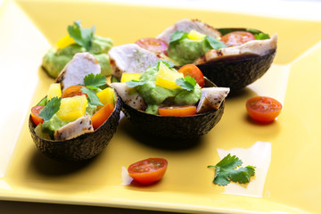avocado filled with chicken salad and avocado dip