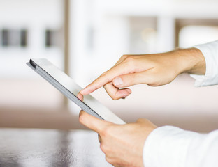 man clicks on a digital tablet