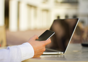 businessman with cell phone and laptop