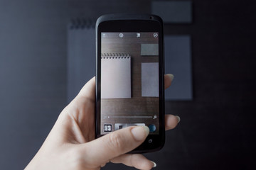 Set of black mockups on dark background,  female hand holding a