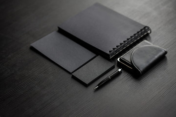 Set of black mockups on dark background,  female hand holding a