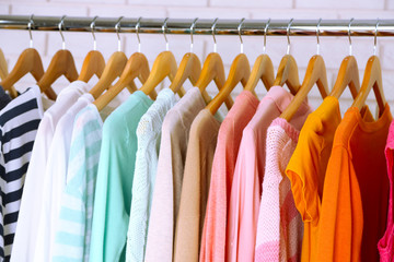 Different clothes on hangers close up