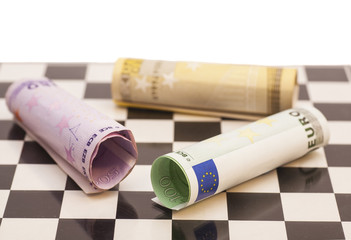 Euro banknotes on chess board