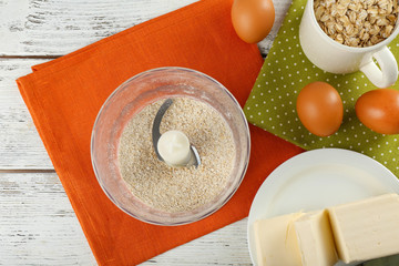 Ingredients for oatmeal cookies on wooden table, top view