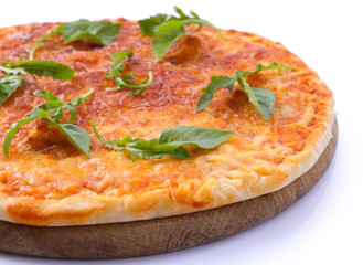 Cheese pizza with herbs on wooden cutting board, closeup