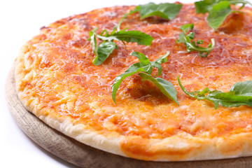 Cheese pizza with herbs on wooden cutting board, closeup
