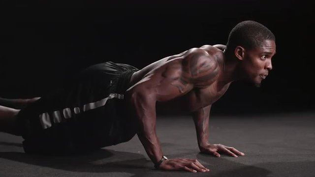 Muscular black man performing military push-ups