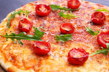 Pizza with arugula and cherry tomatoes, closeup