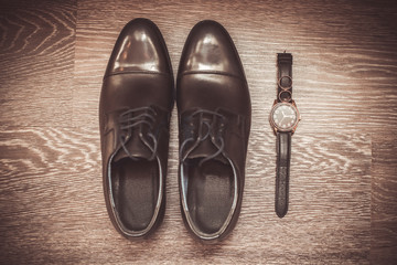 Wedding rings on the clock near the shoe