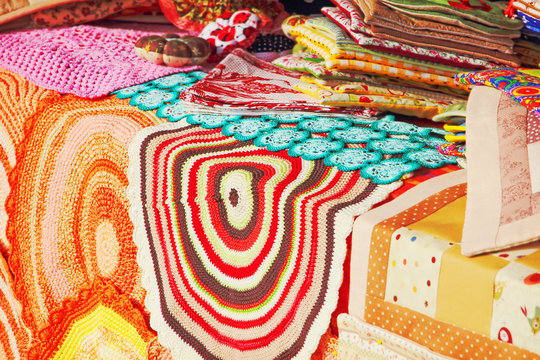 Store Fabric Counter With Multicolored Rugs.