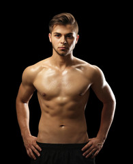 Muscle young man on dark background