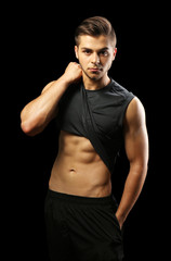 Muscle young man on dark background