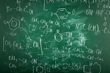 Molecule models and formulas on blackboard background