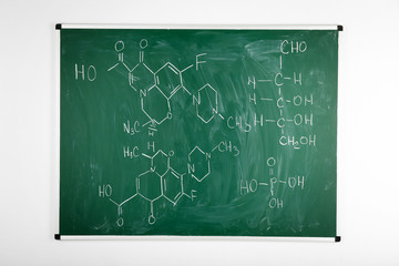 Molecule models and formulas on blackboard background