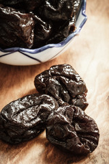 dried plums prunes on wooden table