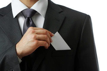 Elegant man in suit holding business card close up