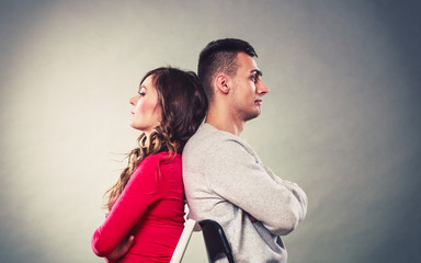 Young couple after quarrel sitting back to back