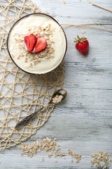 Healthy homemade oatmeal on wooden table, close up